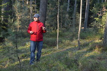 man holding mushrooms in a forest 