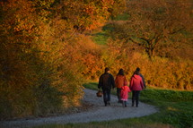 families walking on a path outdoors in autumn