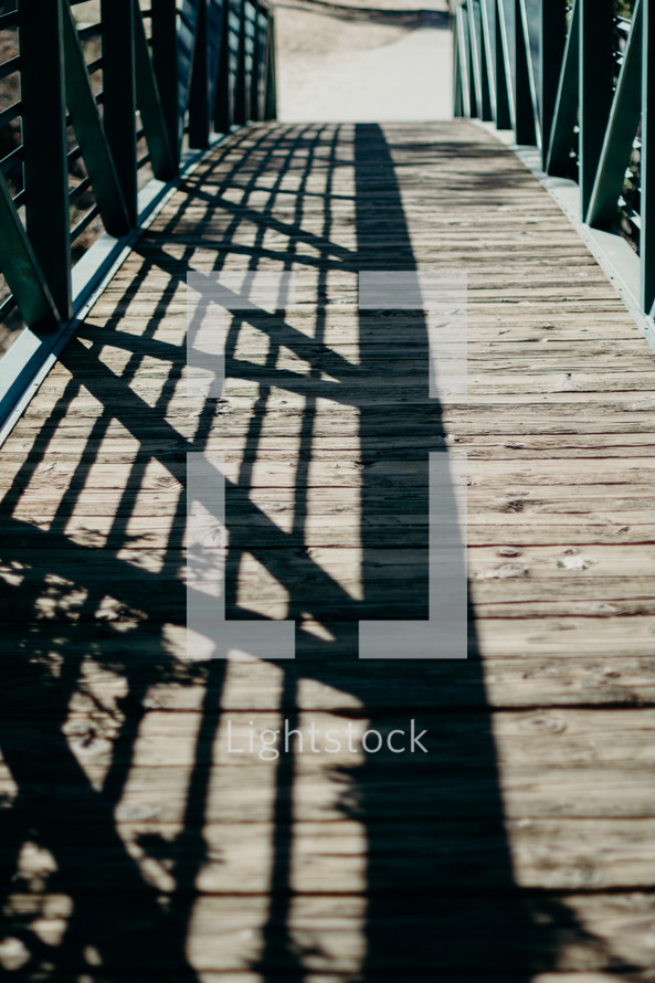 rail shadows on a wood bridge 