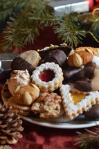 christmas cookies on a plate with christmas decoration. 
Christmas, gingerbread, cookies, cookie, biscuit, delicious, tasty, yummy, delicate, colorful, colourful, multicolored, bake, baking, eating, food, bakery, bakeshop, variety, diversity, richness, nibble, snack, sweets, sweet, pastry, goods, pastries, groceries, edible, eatable, consume, cinnamon, nut, macaroons, marzipan, jam, marmalade, jelly, cooky, chocolate, nougat, choice, selection, assortment, goodies, abundance, plenty, opulence, tradition, self made, handmade, baked, fresh, sugar, icing sugar, powdered sugar, dough, breadboard, bread-board, bread board, biscuits, almond, season, Christmas time, Christmastide, cut out, butter, cut, vanilla crescents, heart, hearts, fir tree, fir trees, walnut, hazelnut, coconut, advent, sharing, friend, friends, hand, hands, take, taking, different, various, divergent, diverse, varied, differing, variable, shape, shapes, kind, sort, plate, give, giving, present, offer, offering, hospitality, invitation, party, joy, celebration, eat, festivity, guest, guests, guest-friendship, invite, see, come, visit, gift, homemade, home made, home-made, self, self-made, celebrate, celebrating, feast, enjoy, relish, savor, savour, appreciate, pick, help oneself, help yourself, empty, full, prepare, preparing, dress, dressing, serve, serving, food arrangement, arrange, arranging, decorate, decorating