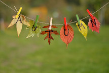 string with leaves and letters spelling: AUTUMN