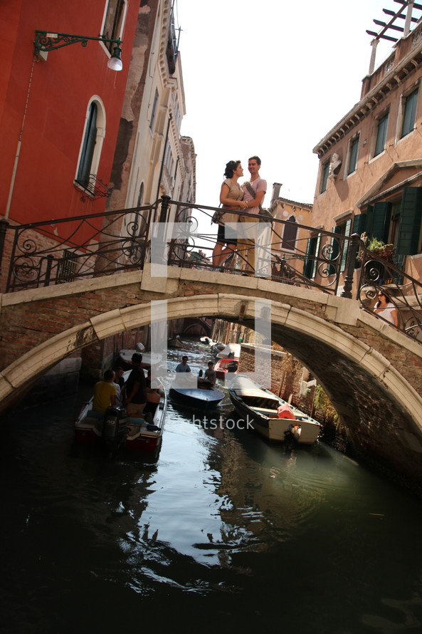 couple on a bridge over a canal in Venice 