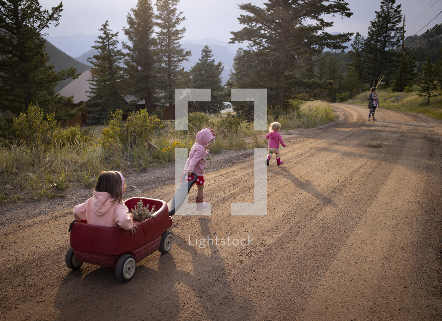 kids walking on a dirt road 