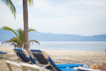 lounge chairs on a tropical beach 