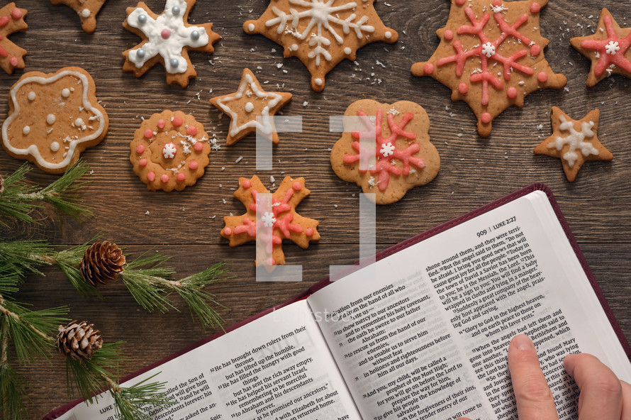 a woman reading a Bible and baking gingerbread Christmas cookies 