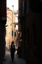 woman walking in a narrow alley in Venice 