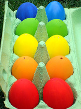 10 multicolored eggs in an egg carton.
