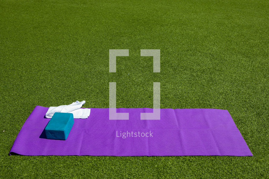 yoga mat in green grass