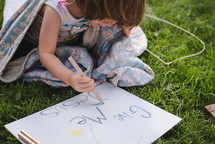 child drawing a give me Jesus sign 