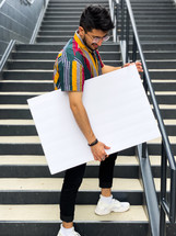 man carrying a blank poster board 
