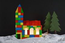 church built out of multicolored different wooden toy blocks as symbol for the community of believers