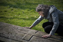 grieving woman at a grave site 