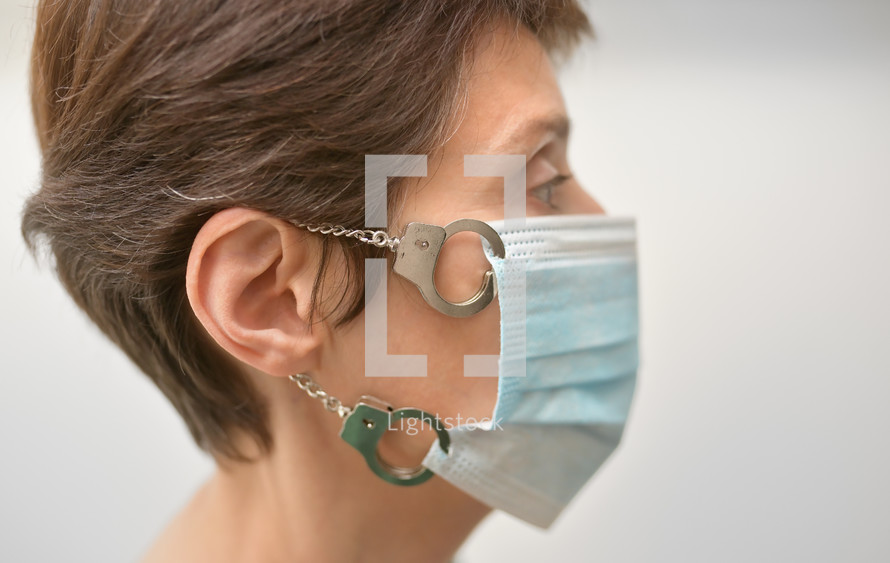 Woman With Medical Mask Locked with Handcuffs