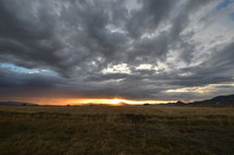 cloudy sky over a field at sunset 