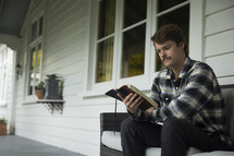 A young man sitting and reading his Bible