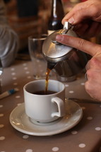 Tea being poured into a cup.