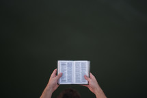 a man reading a pocket Bible 