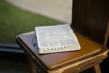 an open Bible in a chair 