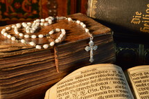 rosary with very old ancient books and bibles in old German lettering