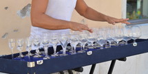 a person playing music with water in wine glasses 
