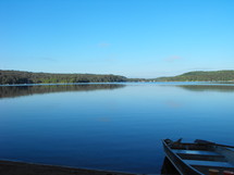 row boat on a lake shore 