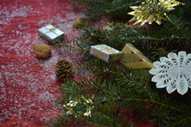 pine, ornaments, snow, and Christmas decorations on a red background 
