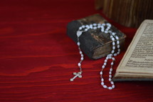 rosary and open Bible 