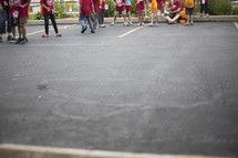 children outdoors in a parking lot