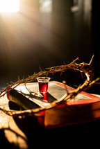crown of thorns and communion cup on a Bible 