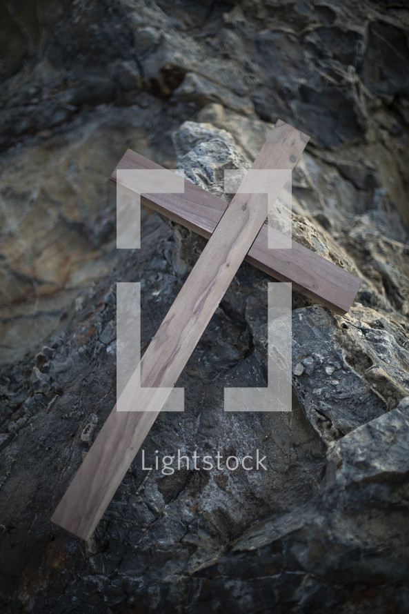 wooden cross on a rock 