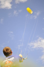 Boy flying a kite.