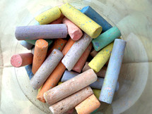Pastel colored chalk with yellow, purple, green, pink, mauve, peach and other pastel colors to be used by an artist, children in school or creative professional to create a work of art in pastels used in art class, art education or a basic drawing course.
