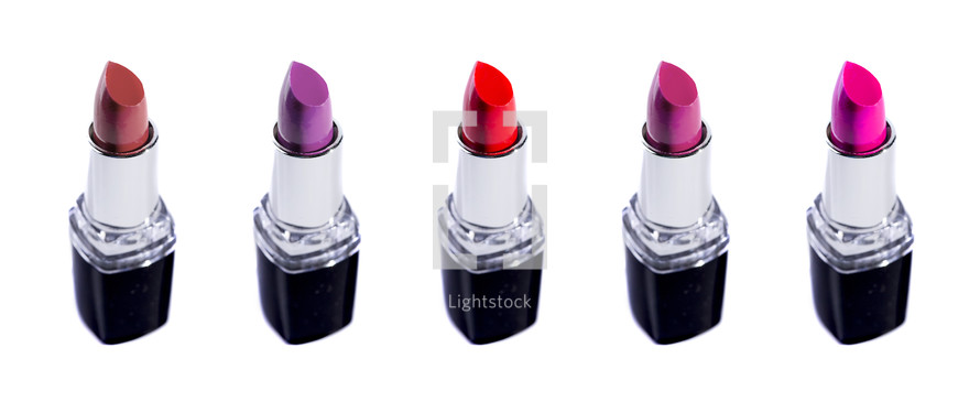 Five Tubes of Different Colored Lipsticks Isolated on a White Background