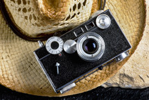 vintage camera on a straw hat 