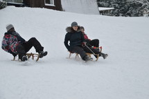 friends sledding in the snow 