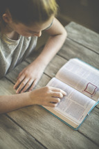a girl reading a Bible 