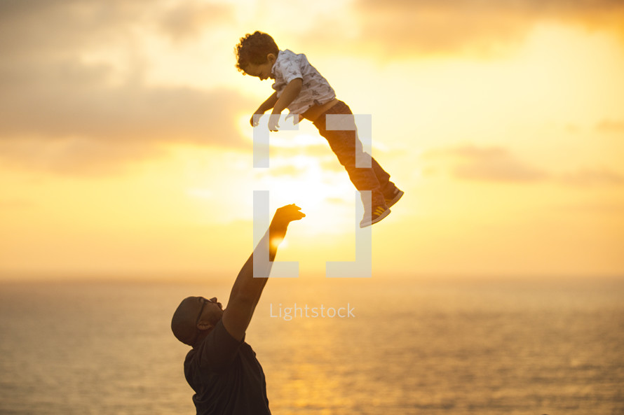 a father lifting up his son 