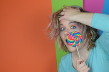woman holding a lollipop 