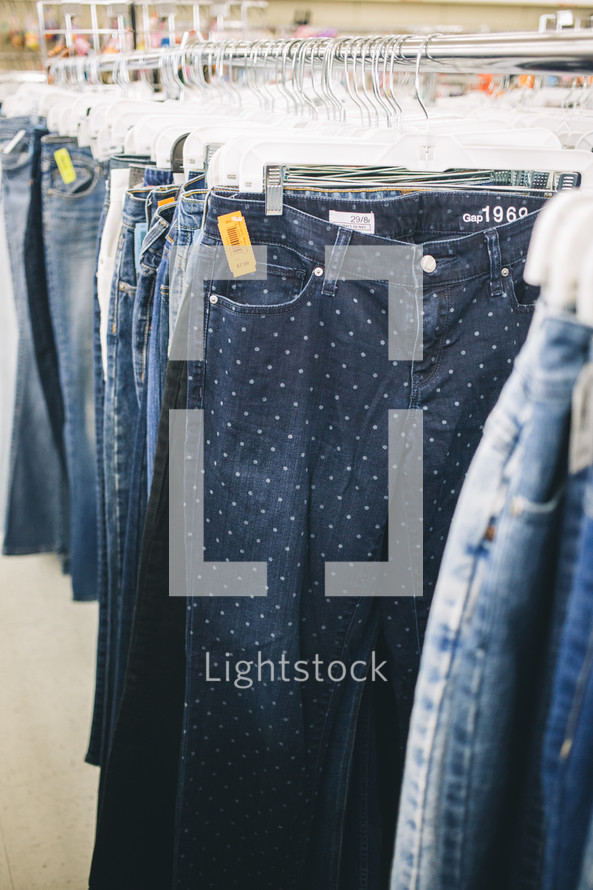 pants and shorts on the rack at a second hand shop 