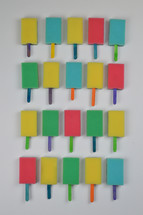 organized background pattern out of colorful self made sponge popsicles as thank you for the volunteer cleaning team in church or as decoration for the vacation bible school in the classroom