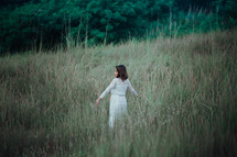 a woman standing in a field 