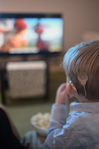 a child with cochlear implants watching TV 