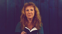 middle aged woman holding a Bible 