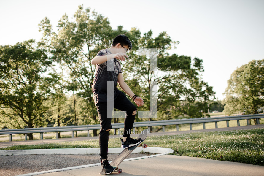 a teen boy with a skateboard 