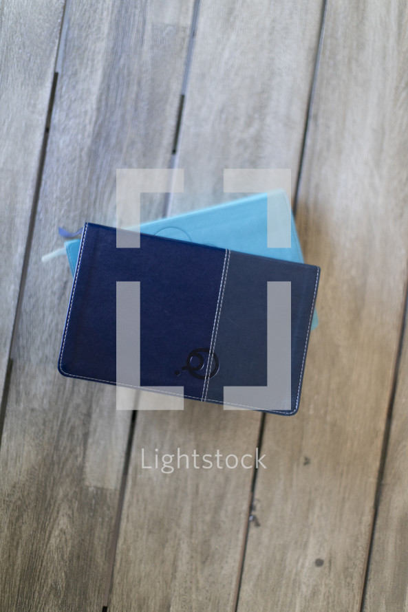 stacked blue Bibles 