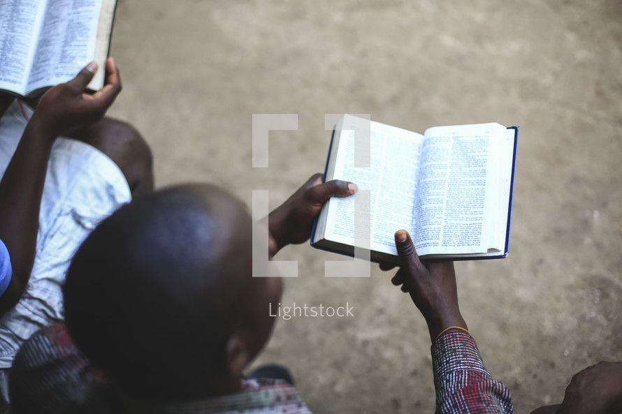 men reading Bibles on a mission trip 