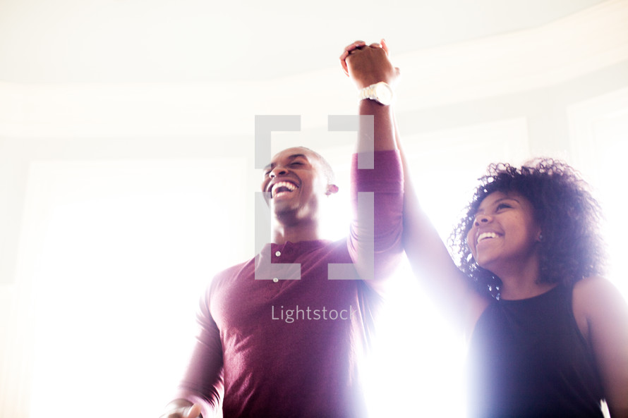 celebration, man, woman, African American, raised hand, holding hands, love, triumphant, victorious, marriage, love, joy, united, smiling, happy, glow