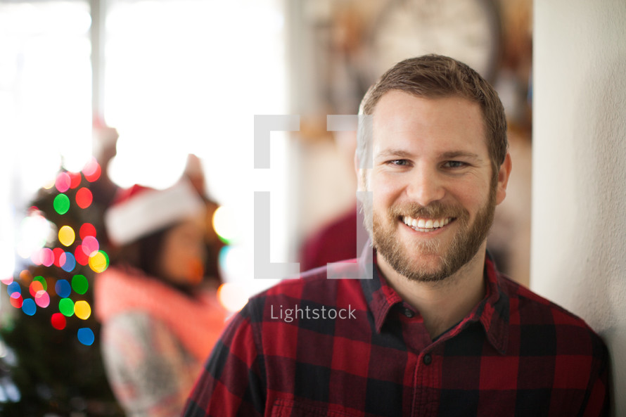 A man smiling at a Christmas party
