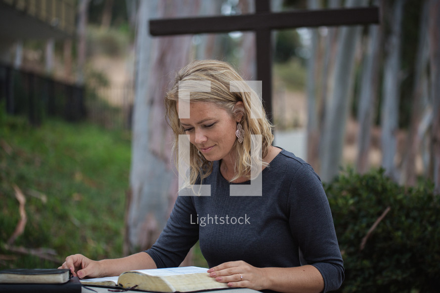 woman reading a Bible outdoors 