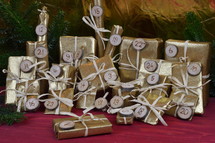 advent calendar with twenty four golden presents on red wood with the numbers burned into round wood pieces
